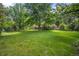 Sprawling backyard with mature trees providing ample shade, offering a serene and private outdoor space at 7 Cherry Hills Farm Dr, Cherry Hills Village, CO 80113
