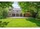 Expansive backyard with lush lawn, a large patio, and an upper-level balcony perfect for outdoor enjoyment at 7 Cherry Hills Farm Dr, Cherry Hills Village, CO 80113