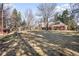 Large backyard featuring mature trees and an exterior view of the home at 7 Cherry Hills Farm Dr, Cherry Hills Village, CO 80113