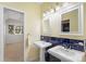 Charming bathroom with dual pedestal sinks and unique tile accents at 7 Cherry Hills Farm Dr, Cherry Hills Village, CO 80113
