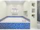 Bathroom featuring a soaking tub with decorative blue tile at 7 Cherry Hills Farm Dr, Cherry Hills Village, CO 80113