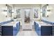 Bathroom featuring dual vanities with bright blue cabinets and white tile flooring at 7 Cherry Hills Farm Dr, Cherry Hills Village, CO 80113