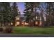 The house is surrounded by mature trees and has a beautiful lawn at 7 Cherry Hills Farm Dr, Cherry Hills Village, CO 80113