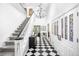 Grand foyer featuring black and white checkered floors, staircase and stained glass at 7 Cherry Hills Farm Dr, Cherry Hills Village, CO 80113