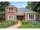 Inviting brick home with a brick walkway leading to the front door and landscaped garden at 7 Cherry Hills Farm Dr, Cherry Hills Village, CO 80113