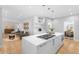Modern kitchen with stainless steel appliances and an island with a gas cooktop at 7 Cherry Hills Farm Dr, Cherry Hills Village, CO 80113