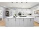 Modern kitchen with white cabinetry, stainless steel appliances, and a large kitchen island at 7 Cherry Hills Farm Dr, Cherry Hills Village, CO 80113
