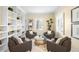 Bright living room with built-in bookshelves, four armchairs and a window with white shutters at 7 Cherry Hills Farm Dr, Cherry Hills Village, CO 80113