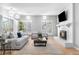 Bright living room featuring a white brick fireplace and sliding doors to the backyard at 7 Cherry Hills Farm Dr, Cherry Hills Village, CO 80113