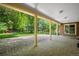 Covered patio featuring brick accents and a stone floor, providing an ideal space for outdoor entertaining at 7 Cherry Hills Farm Dr, Cherry Hills Village, CO 80113