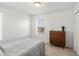 Relaxing bedroom showcasing a bed, dresser, and window offering comfort and natural light at 6024 High Timber Cir, Castle Rock, CO 80104