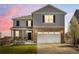 Charming two-story home with stone accents, a two-car garage, and a well-manicured lawn at 6024 High Timber Cir, Castle Rock, CO 80104