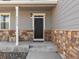 Inviting front porch featuring stone accents and updated fixtures for a welcoming entrance at 6024 High Timber Cir, Castle Rock, CO 80104