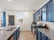 Modern kitchen boasts stainless appliances, granite counters, stylish backsplash, and bright natural light at 6024 High Timber Cir, Castle Rock, CO 80104