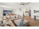 Open-concept living room with hardwood floors seamlessly flowing into the modern kitchen at 6024 High Timber Cir, Castle Rock, CO 80104