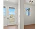 Bright room features new vinyl flooring, a doorway to the outside, and a double-hung window at 2849 E 103Rd Dr, Thornton, CO 80229
