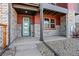 Inviting townhome entrance with a colorful door and stylish stone accents at 2849 E 103Rd Dr, Thornton, CO 80229