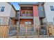 Charming townhome featuring colorful siding, stone accents, and private balconies at 2849 E 103Rd Dr, Thornton, CO 80229