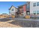 Inviting townhome exterior with stone accents, colorful siding, and a charming fenced yard at 2849 E 103Rd Dr, Thornton, CO 80229