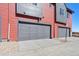Modern garage exterior featuring a gray door and colorful siding at 2849 E 103Rd Dr, Thornton, CO 80229
