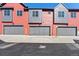 Modern townhome garages featuring gray doors and complementary siding at 2849 E 103Rd Dr, Thornton, CO 80229