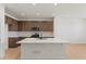 Modern kitchen featuring a large island, stainless steel appliances, and wood flooring at 2849 E 103Rd Dr, Thornton, CO 80229