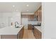 Open kitchen with stainless steel appliances, light countertops, and dark brown cabinetry at 2849 E 103Rd Dr, Thornton, CO 80229