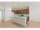 Well-lit kitchen featuring a kitchen island, stainless appliances, and hardwood floors at 2849 E 103Rd Dr, Thornton, CO 80229