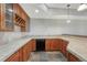 Elegant bar featuring custom wood cabinets, tile countertops, a sink, and modern appliances at 1252 Rosewind Cir, Castle Rock, CO 80104
