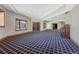 Spacious basement offering natural light, patterned carpet, and a vintage upright piano at 1252 Rosewind Cir, Castle Rock, CO 80104