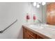 Bathroom featuring light-colored walls, neutral countertops, wood cabinets, and an open sink at 1252 Rosewind Cir, Castle Rock, CO 80104