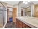 Well-lit bathroom featuring tile floor, a modern vanity, and a glass-enclosed shower at 1252 Rosewind Cir, Castle Rock, CO 80104