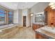 Luxurious bathroom with a soaking tub, walk-in shower, and double vanity at 1252 Rosewind Cir, Castle Rock, CO 80104