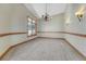 Open dining area with carpet, chandelier, wood trim, and natural light at 1252 Rosewind Cir, Castle Rock, CO 80104