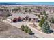 Expansive luxury home boasts meticulous landscaping and a circular driveway with a water feature at 1252 Rosewind Cir, Castle Rock, CO 80104
