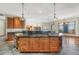 Spacious kitchen with a large island featuring dark countertops, wood cabinets, and modern lighting at 1252 Rosewind Cir, Castle Rock, CO 80104