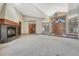 Bright living space with a fireplace, chandelier, and large entry doors at 1252 Rosewind Cir, Castle Rock, CO 80104