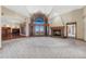 Spacious living room with a fireplace, large windows, and neutral tones overlooking great views at 1252 Rosewind Cir, Castle Rock, CO 80104