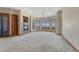 Bright living room with large windows, a fireplace, and plush carpeting at 1252 Rosewind Cir, Castle Rock, CO 80104
