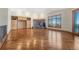 Open living room featuring wood floors, a stone fireplace, built-in cabinets, and large windows with scenic views at 1252 Rosewind Cir, Castle Rock, CO 80104