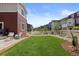 Fenced backyard with artificial grass, rock landscaping, and fire pit offers a private outdoor space at 5297 Blue Lunar Ln, Castle Rock, CO 80104
