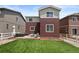 A well-kept backyard featuring green grass, patio furniture, and a cozy fire pit area at 5297 Blue Lunar Ln, Castle Rock, CO 80104