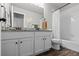 Bright bathroom featuring a double vanity, granite countertops, and a tiled shower with glass doors at 5297 Blue Lunar Ln, Castle Rock, CO 80104