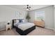 A cozy bedroom features a ceiling fan, window, and a comfortable bed with blue accents at 5297 Blue Lunar Ln, Castle Rock, CO 80104