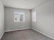 A carpeted, unfurnished bedroom with two windows offering plenty of natural light and ventilation at 5297 Blue Lunar Ln, Castle Rock, CO 80104