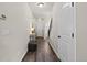 Hallway featuring wood-look floors, a console table, and access to the staircase at 5297 Blue Lunar Ln, Castle Rock, CO 80104