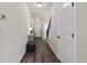 Hallway with wood-look floors, a console table, and access to the staircase at 5297 Blue Lunar Ln, Castle Rock, CO 80104
