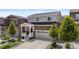 Charming two-story home with brick accents, a well-manicured lawn, and an attached two-car garage at 5297 Blue Lunar Ln, Castle Rock, CO 80104