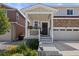 Inviting front porch with decorative flowers and a stylish front door, enhancing the home's curb appeal at 5297 Blue Lunar Ln, Castle Rock, CO 80104