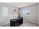 Home office with large windows for natural light, desk, and floating shelves perfect for work or study at 5297 Blue Lunar Ln, Castle Rock, CO 80104